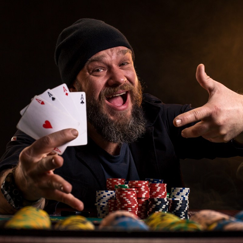 bearded man with poker cards